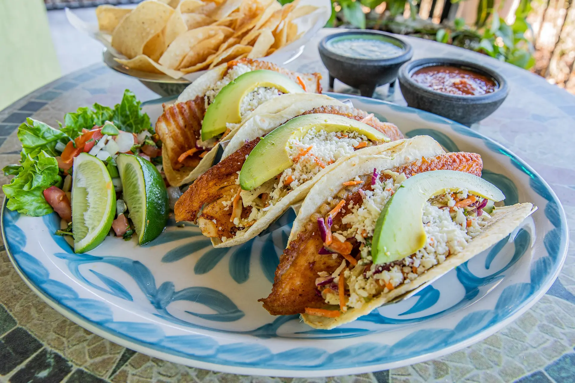 Iguana Joe’s fish tacos with avocado, slaw, pico, lime and chips
