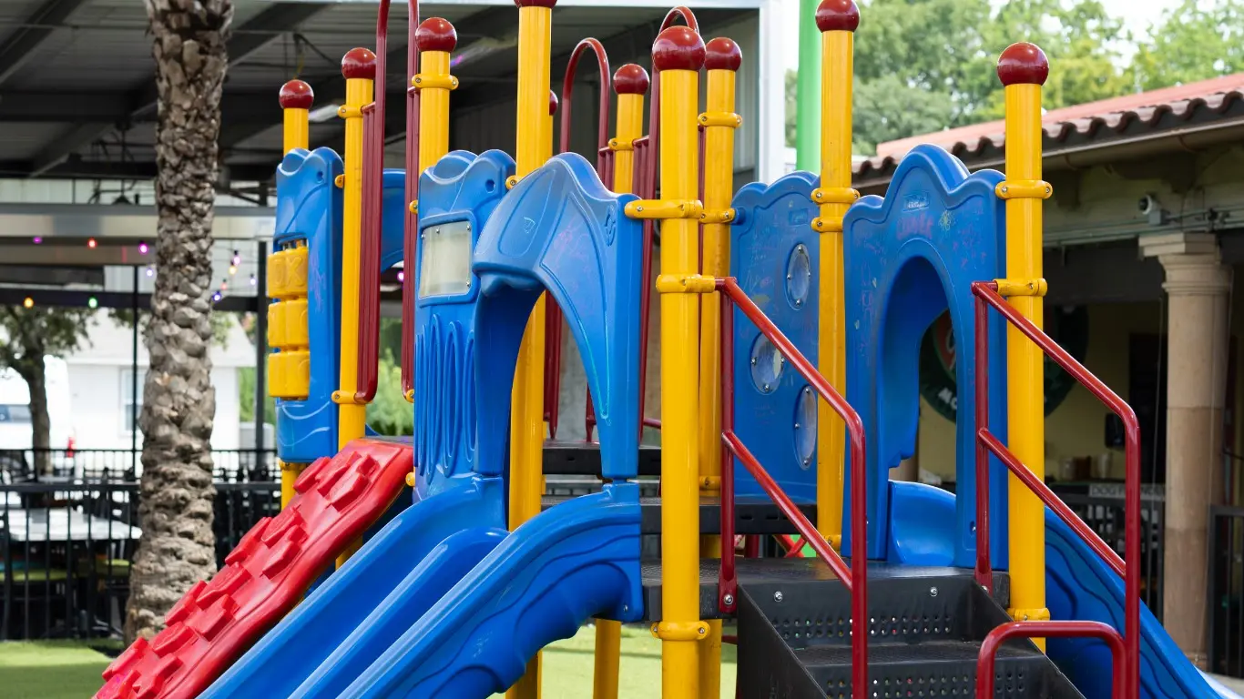 Colorful playground with slides and climbing equipment at Iguana Joe’s
